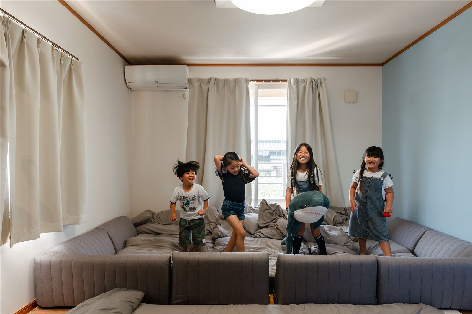 キッズルームの大きなソファベッドで遊ぶ子どもたち